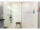 Walk-in shower with white subway tile, glass enclosure, overhead shower, and black wood stool at 2425 W Bronco Butte Trl # 2028, Phoenix, AZ 85085