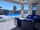 Relaxing outdoor living space with covered patio, pool, spa, and comfortable seating at 25602 S 229Th Pl, Queen Creek, AZ 85142