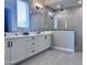 Modern bathroom features dual sinks, quartz countertops, large mirrors, and a glass enclosed shower at 25602 S 229Th Pl, Queen Creek, AZ 85142