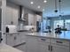 Spacious kitchen featuring white cabinets, a large island, stainless steel appliances, and recessed lighting at 25602 S 229Th Pl, Queen Creek, AZ 85142