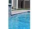 Close-up view of a sparkling pool with tile accents, clear water, and lush surroundings at 25602 S 229Th Pl, Queen Creek, AZ 85142