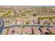 This aerial view captures a desert community adjacent to a golf course with residential homes in Arizona at 2599 E San Mateo Dr, Casa Grande, AZ 85194