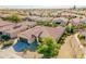 Stunning aerial view of a residential area showcasing the house with a terracotta tile roof at 2599 E San Mateo Dr, Casa Grande, AZ 85194