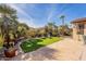 Lush backyard with artificial grass, stone patio, and seating, ideal for relaxation and outdoor enjoyment at 2599 E San Mateo Dr, Casa Grande, AZ 85194