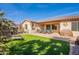 Relaxing backyard with artificial grass, patio, desert landscaping, and seating area offers a perfect spot for outdoor enjoyment at 2599 E San Mateo Dr, Casa Grande, AZ 85194