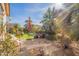 Lush landscaping, gravel, potted plants, and artificial grass create a serene backyard oasis at 2599 E San Mateo Dr, Casa Grande, AZ 85194