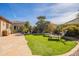Well-maintained backyard featuring lush landscaping, a stone patio, and a relaxing outdoor area at 2599 E San Mateo Dr, Casa Grande, AZ 85194