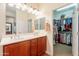 Bathroom with dual sinks and a large walk-in closet with ample hanging space at 2599 E San Mateo Dr, Casa Grande, AZ 85194