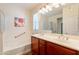 Bright bathroom featuring a double sink vanity, soaking tub, and a large framed mirror at 2599 E San Mateo Dr, Casa Grande, AZ 85194