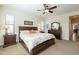 Bedroom with warm lighting, a ceiling fan, and coordinated dark wood furniture at 2599 E San Mateo Dr, Casa Grande, AZ 85194