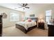 Bedroom with a ceiling fan, dark wood furniture, and abundant natural light at 2599 E San Mateo Dr, Casa Grande, AZ 85194