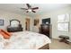 Bedroom with a ceiling fan, rich wood furniture, and natural light from a window at 2599 E San Mateo Dr, Casa Grande, AZ 85194