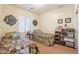 Neutral bedroom featuring two twin beds with decorative floral patterns and wall decor at 2599 E San Mateo Dr, Casa Grande, AZ 85194