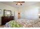 Bedroom with a ceiling fan, a dresser with a mirror, and a hallway doorway at 2599 E San Mateo Dr, Casa Grande, AZ 85194