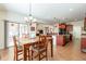 Open dining area with a wood table, chandelier, and kitchen views at 2599 E San Mateo Dr, Casa Grande, AZ 85194