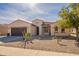 Charming single-story home with a two-car garage, desert landscaping, and a tile roof in a sunny setting at 2599 E San Mateo Dr, Casa Grande, AZ 85194