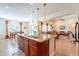 Kitchen island with stainless steel sink and seating in an open layout at 2599 E San Mateo Dr, Casa Grande, AZ 85194
