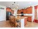Well-lit kitchen showcasing wood cabinets, a black fridge, and a breakfast bar at 2599 E San Mateo Dr, Casa Grande, AZ 85194