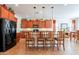 Open kitchen with wood cabinets, black appliances, and pendant lighting at 2599 E San Mateo Dr, Casa Grande, AZ 85194