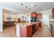 Open-concept kitchen with island, bar seating, and adjacent living area at 2599 E San Mateo Dr, Casa Grande, AZ 85194