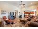 Inviting living room featuring a cozy fireplace, media center, and an open-concept layout with tile floors at 2599 E San Mateo Dr, Casa Grande, AZ 85194