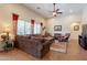 Comfortable living room with a large sofa, patterned rug, and abundant natural light from the windows at 2599 E San Mateo Dr, Casa Grande, AZ 85194