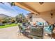Covered patio with comfortable seating and view of the well-manicured backyard at 2599 E San Mateo Dr, Casa Grande, AZ 85194