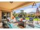 Covered patio with comfortable seating and well-manicured lawn provides an ideal outdoor living space at 2599 E San Mateo Dr, Casa Grande, AZ 85194