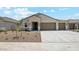 Inviting single-story home with a neutral color palette, desert landscaping, and a two-car garage at 2640 W Stanton Ave, Apache Junction, AZ 85120