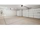 Spacious three car garage with white doors and an electric water heater at 2640 W Stanton Ave, Apache Junction, AZ 85120