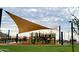 Community playground featuring slides and play structures covered with a sunshade at 3279 W Molino Rd, San Tan Valley, AZ 85144
