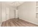This bedroom features wood-look floors, neutral paint, and ensuite bathroom access at 3307 E Roveen Ave, Phoenix, AZ 85032