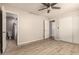This bedroom features wood-look floors, neutral paint, and ensuite bathroom access at 3307 E Roveen Ave, Phoenix, AZ 85032