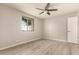 This bedroom features wood-look floors, neutral paint, and a ceiling fan at 3307 E Roveen Ave, Phoenix, AZ 85032