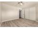 This bedroom has wood-look floors, neutral paint, and sliding closet doors at 3307 E Roveen Ave, Phoenix, AZ 85032