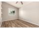 This bedroom features wood-look floors, neutral paint, and natural light at 3307 E Roveen Ave, Phoenix, AZ 85032