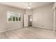 This bedroom has wood-look floors, neutral paint, and a ceiling fan at 3307 E Roveen Ave, Phoenix, AZ 85032