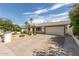 Inviting single-story home with a two-car garage and desert landscaping at 3307 E Roveen Ave, Phoenix, AZ 85032