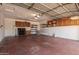 This spacious garage features cabinet storage and shelving units at 3307 E Roveen Ave, Phoenix, AZ 85032