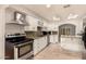 Updated kitchen with white cabinets, granite countertops, and stainless steel appliances at 3307 E Roveen Ave, Phoenix, AZ 85032