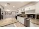 Open kitchen featuring granite counters, stainless appliances, and breakfast bar at 3307 E Roveen Ave, Phoenix, AZ 85032