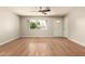 Bright living room with hardwood floors, ceiling fan, and large window at 3307 E Roveen Ave, Phoenix, AZ 85032
