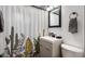 Bathroom featuring a white vanity, cactus-themed shower curtain, and modern fixtures at 3330 E Cypress St, Phoenix, AZ 85008