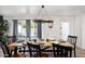 Bright dining room with a large wooden table, modern chandelier, and ample natural light at 3330 E Cypress St, Phoenix, AZ 85008