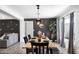 Elegant dining room with modern lighting, stylish decor, and a view into the living area at 3330 E Cypress St, Phoenix, AZ 85008