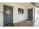 Inviting front entrance featuring a welcome sign, gray doors, and clean white brickwork at 3330 E Cypress St, Phoenix, AZ 85008