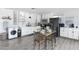 Modern kitchen with white cabinetry, stainless steel appliances, and dining area at 3330 E Cypress St, Phoenix, AZ 85008