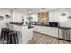 Modern kitchen with white cabinetry, black countertops, stainless steel appliances, and stylish backsplash at 3330 E Cypress St, Phoenix, AZ 85008