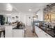 Contemporary kitchen with white cabinets, stainless steel appliances, and stylish breakfast bar seating at 3330 E Cypress St, Phoenix, AZ 85008