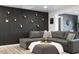 Comfortable living room with modern decor, a large gray sectional, and stylish accent wall at 3330 E Cypress St, Phoenix, AZ 85008